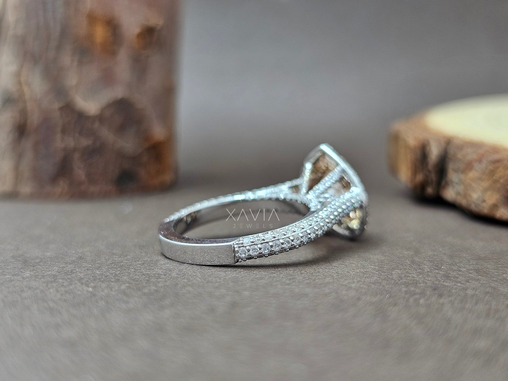 Silver ring with gemstones on a wooden surface - Xavia Jewels