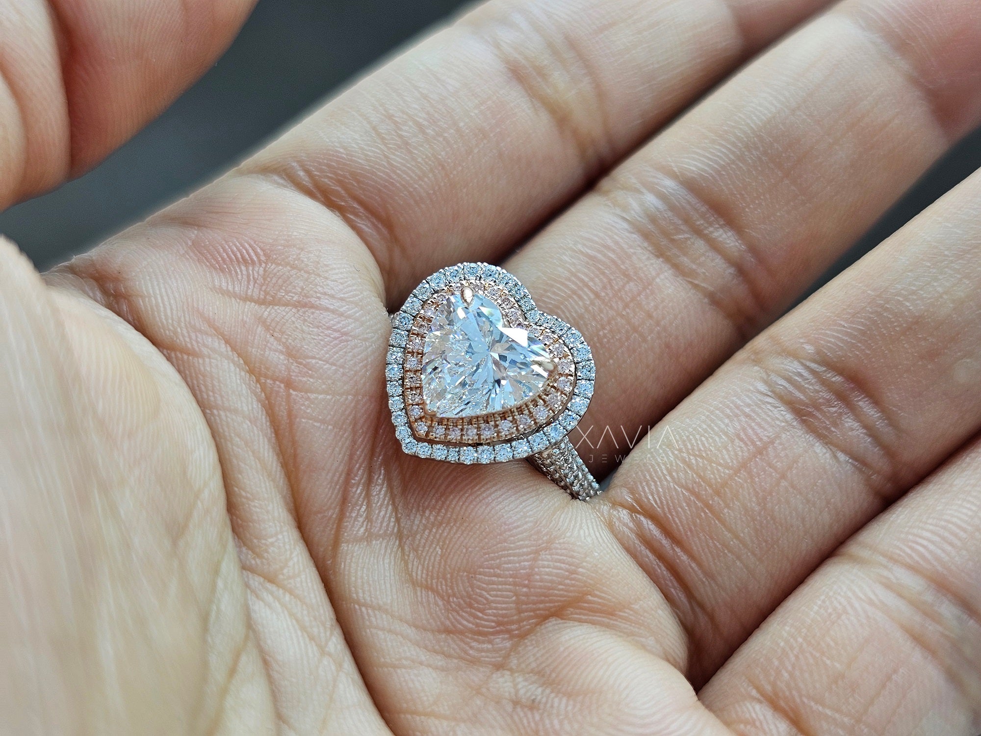 Heart-shaped diamond ring on a hand - Xavia Jewels