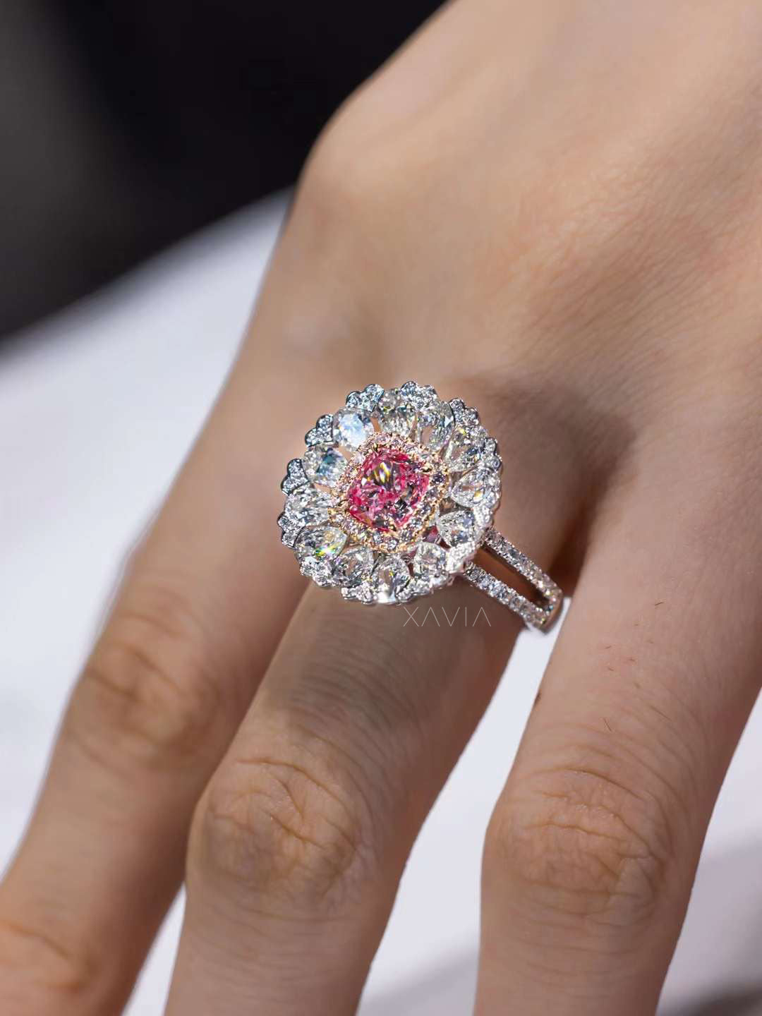 angled hand shot of cushion pink diamond halo ring with pavé split shank sparkle