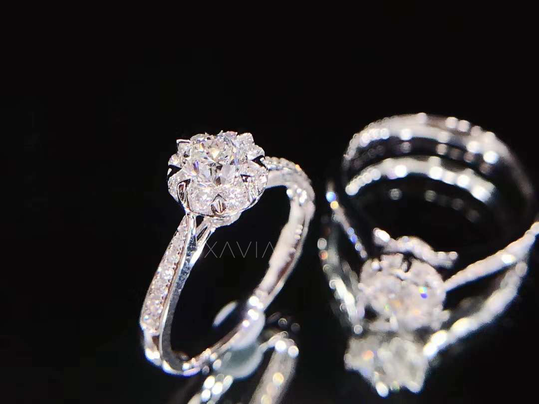 Angled perspective of round brilliant lab diamond halo engagement ring showcasing raised prongs, pavé shoulders and reflective black base