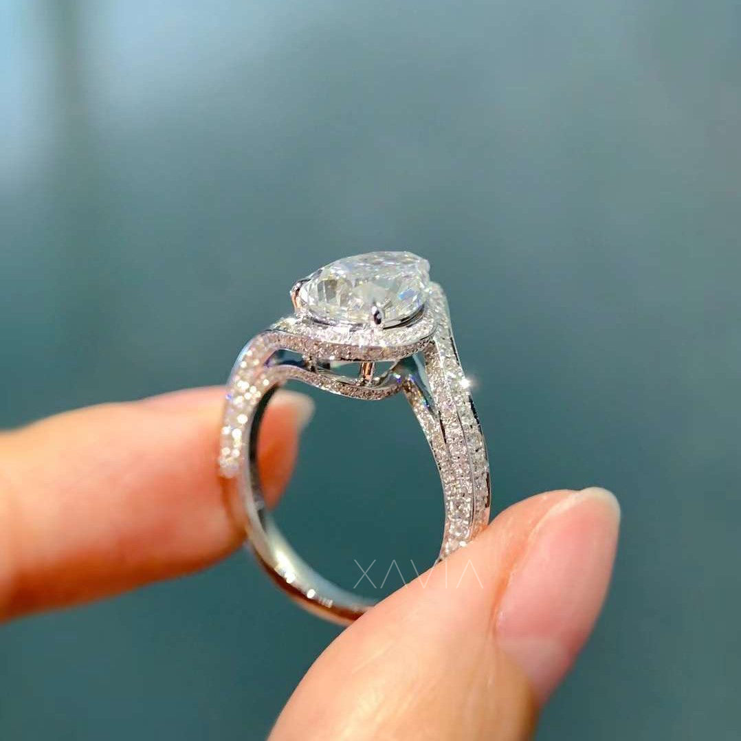 angled view of pear shaped halo diamond ring with split pavé band