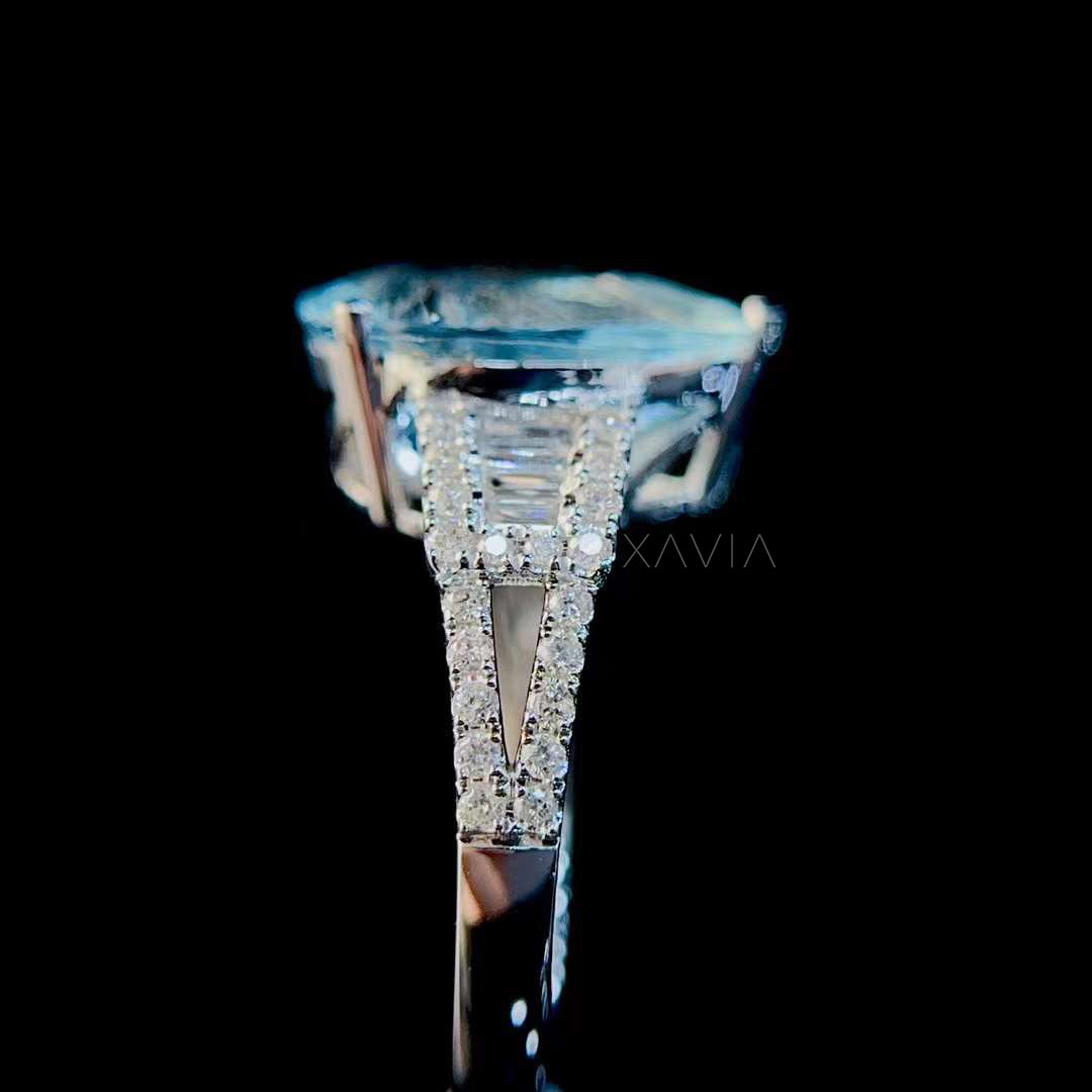 Side profile of pear aquamarine engagement ring showing baguette diamond halo and split shank pavé band with elegant elevated gallery structure