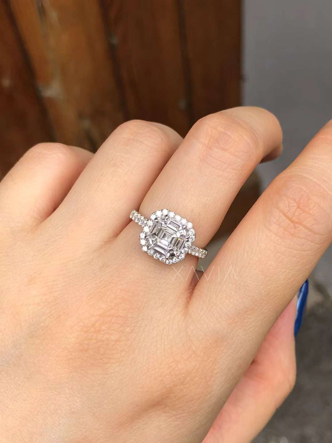 detailed macro of asscher diamond ring with baguette cluster halo and round diamonds showcasing craftsmanship and stone arrangement