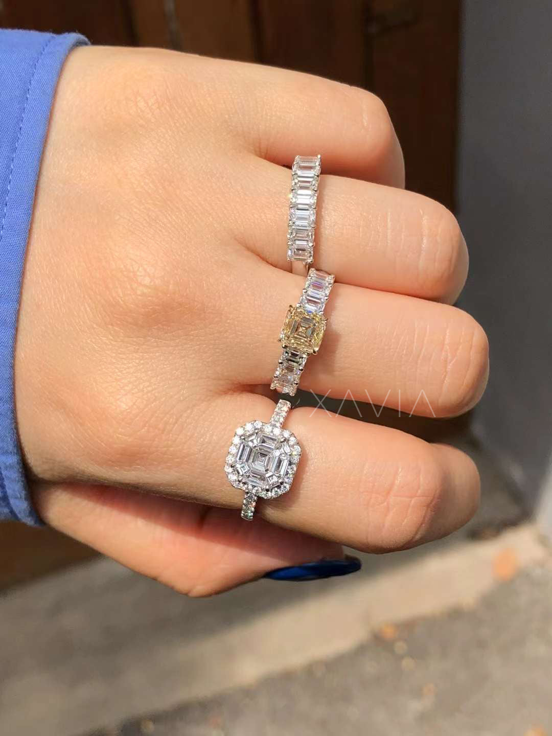 lifestyle image of asscher cut diamond halo ring worn on hand emphasizing symmetry, brilliance, and pavé band detail