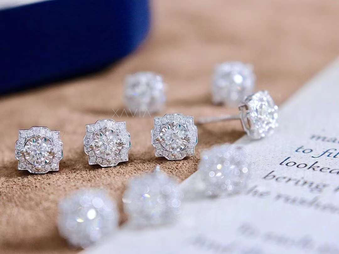 Close-up group shot of illusion halo round diamond studs on soft velvet