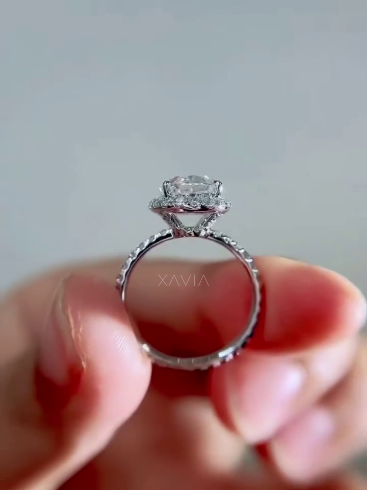 side profile of oval halo lab grown diamond engagement ring with cathedral gallery setting and pavé diamond shank in polished white metal