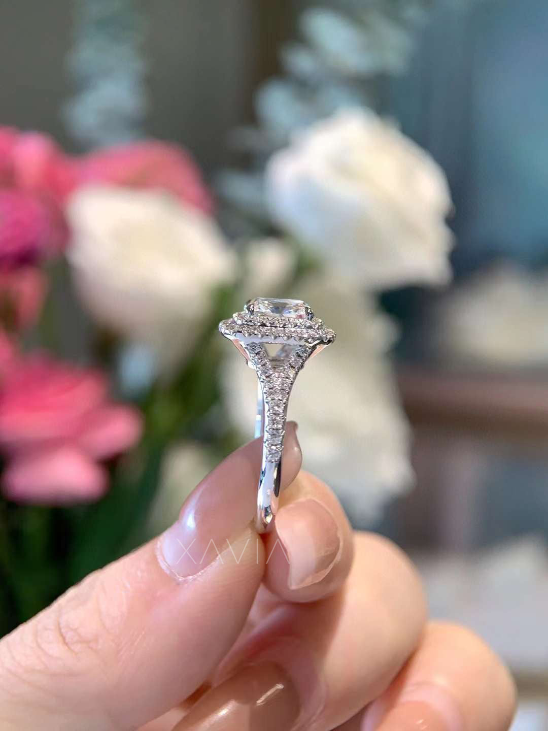 elegant side profile of cushion diamond ring with pavé cathedral setting and raised double halo