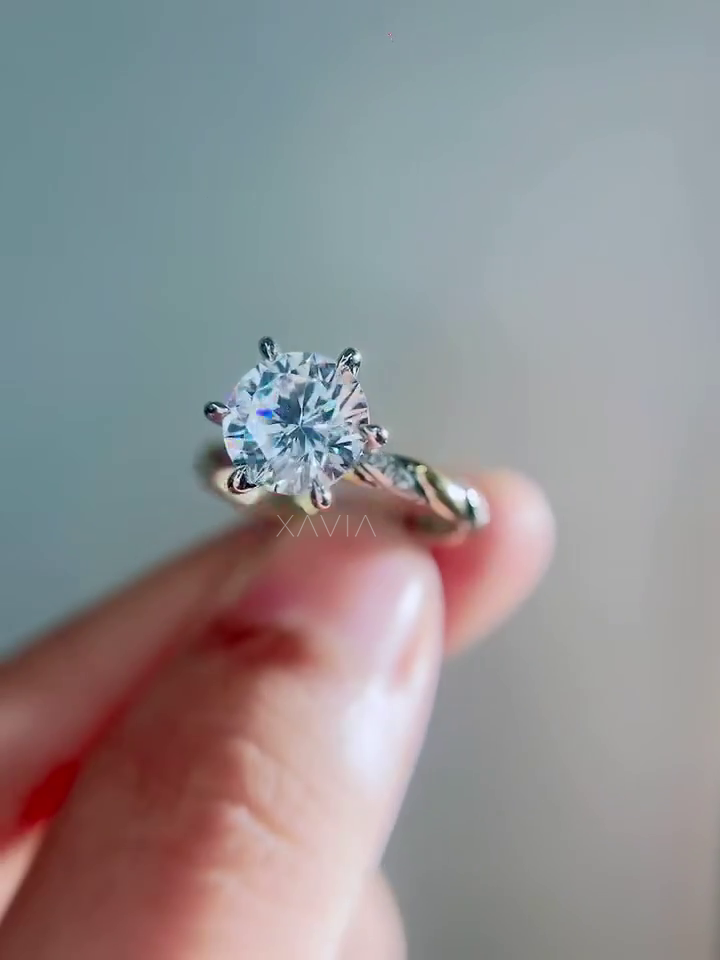 close angled profile of round brilliant lab grown diamond engagement ring showing cathedral mounting and twisted pavé diamond band details