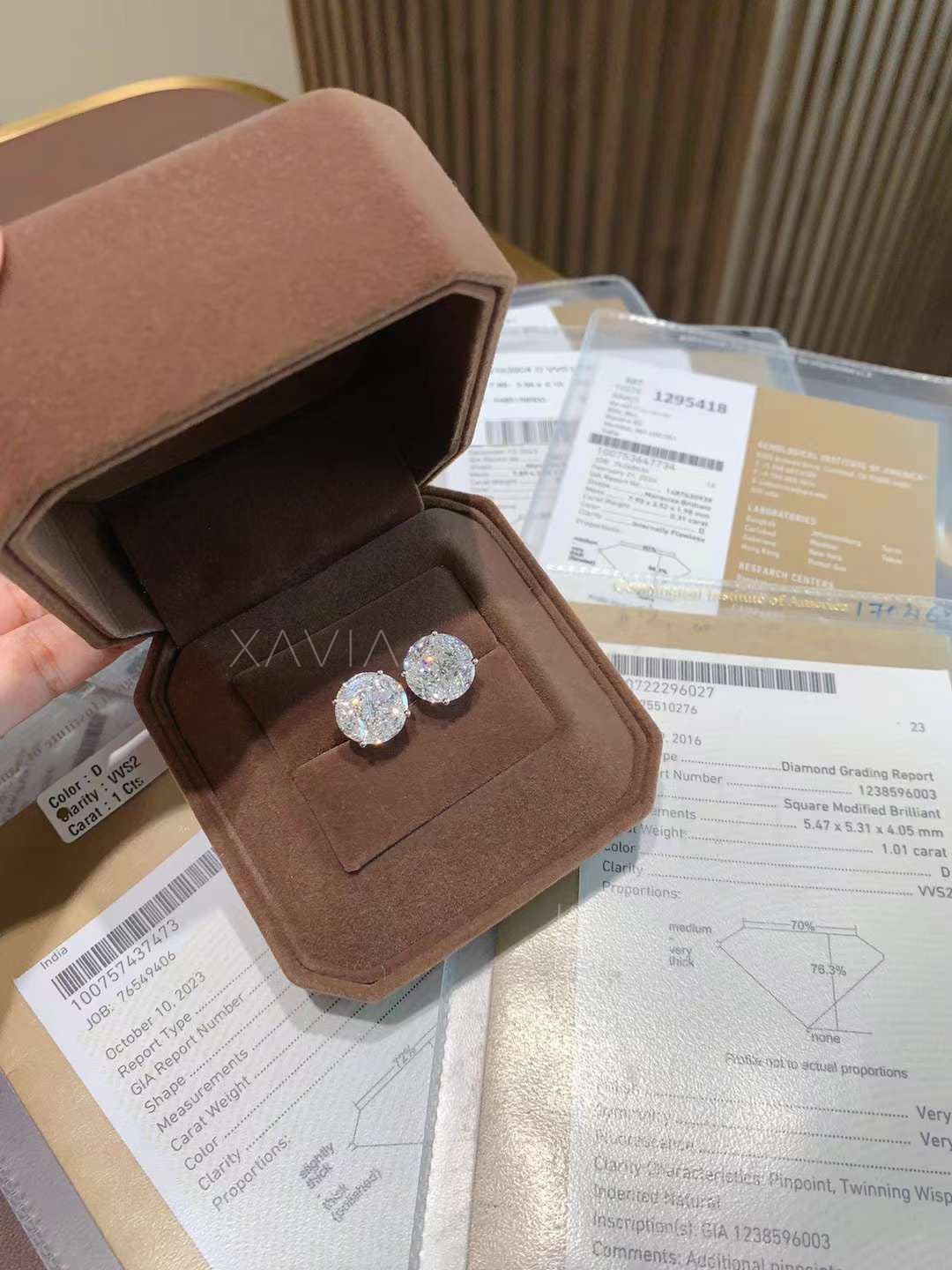 Diamond illusion earrings shown in box and GIA paperwork