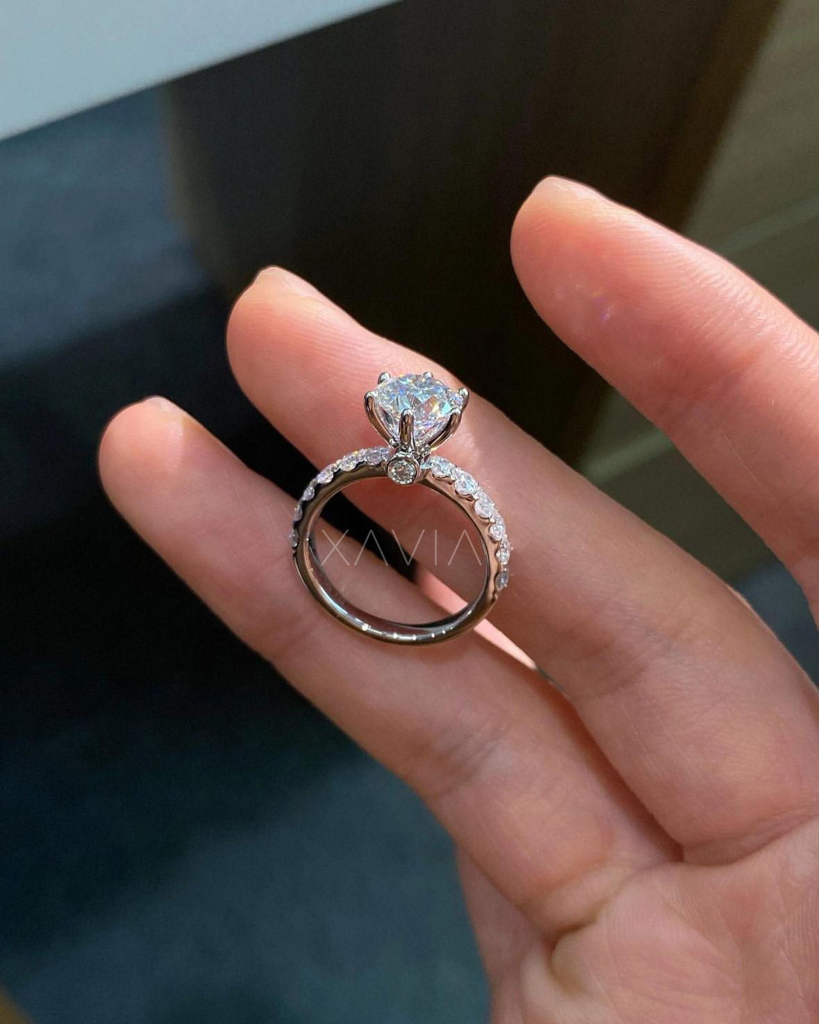 angled view showing claw prong and pavé detailing on engagement ring