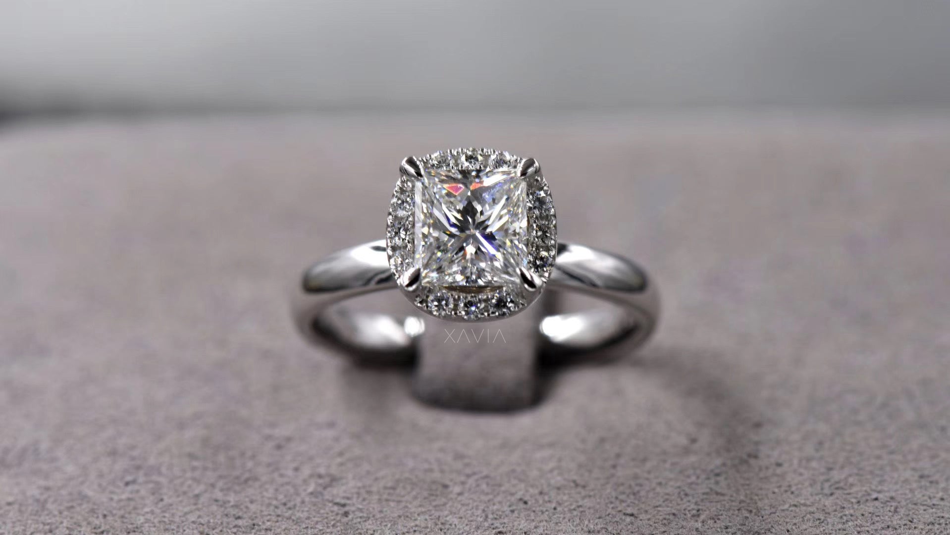 close up view highlighting princess cut lab grown diamond brilliance with crescent shaped halo accent diamonds and refined minimalist band