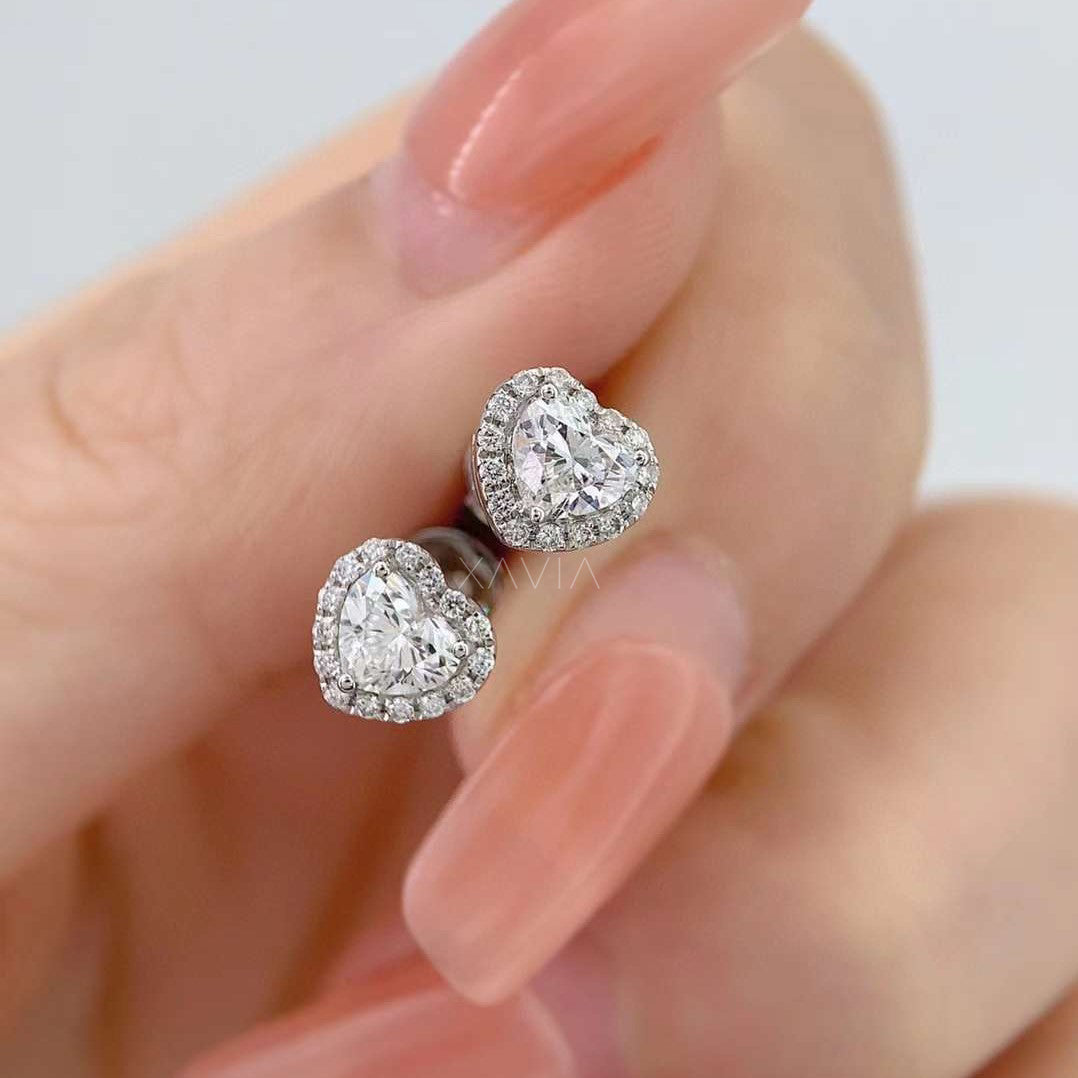 Close-up of illusion halo earrings showing heart center and pavé diamond surround
