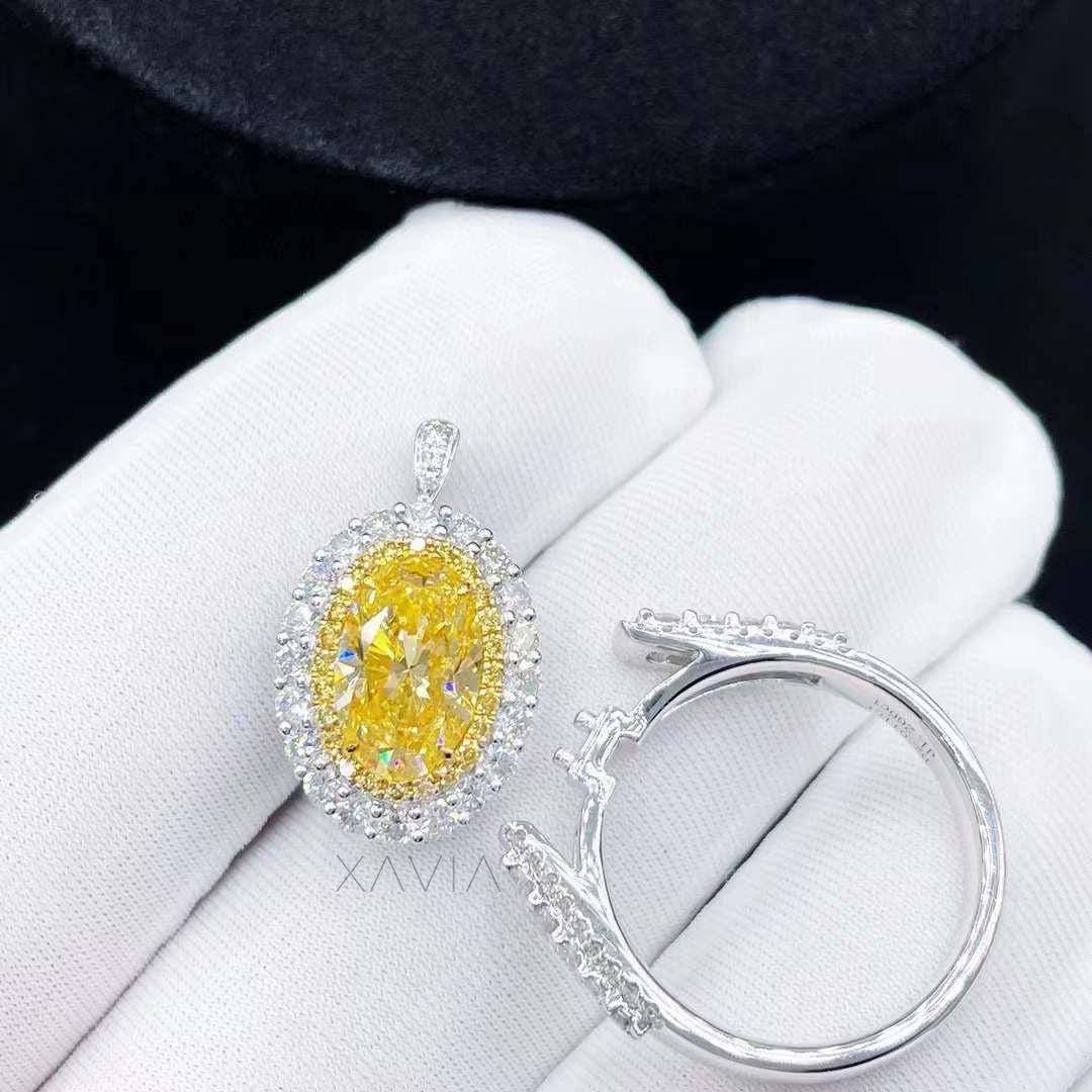 convertible oval fancy vivid yellow diamond halo ring and detachable pendant in platinum displayed on white gloves