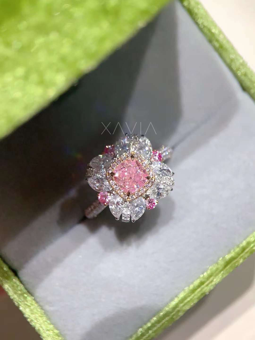pink diamond ring with petal halo displayed in green box