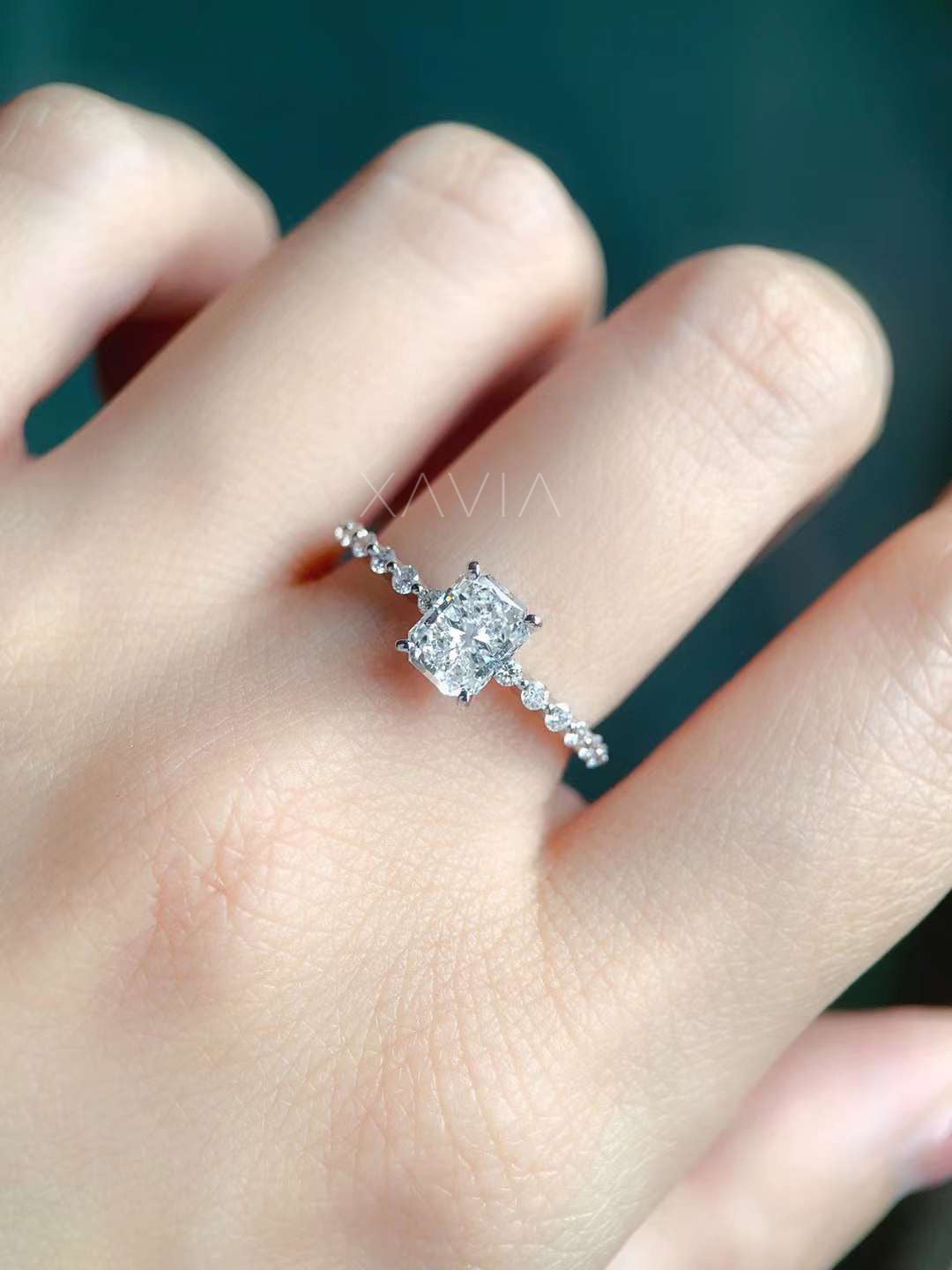 Cushion cut lab diamond engagement ring on model hand with slim pavé diamond band showing delicate luxury bridal jewelry design