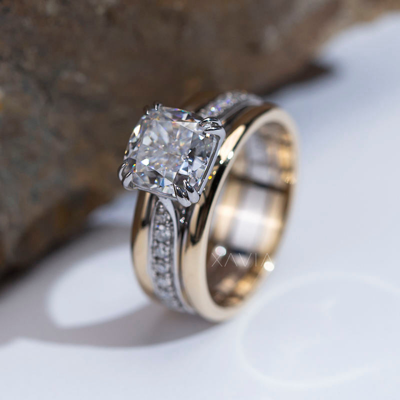 angled side profile of cushion cut lab grown diamond engagement ring with elevated prong setting, pavé diamond channel on split band and polished gold stack band