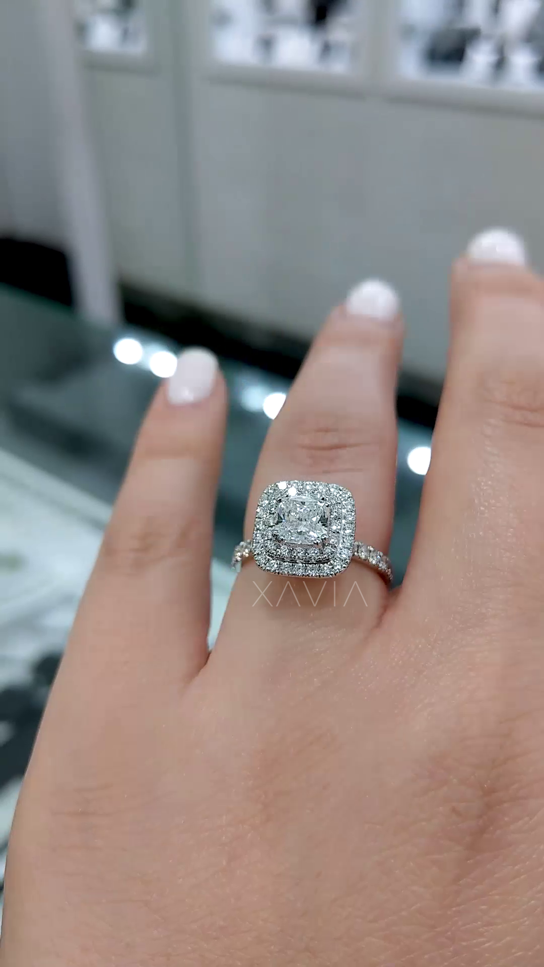 cushion cut lab grown diamond ring with double halo and pavé split shank worn on hand showing finger coverage and brilliance