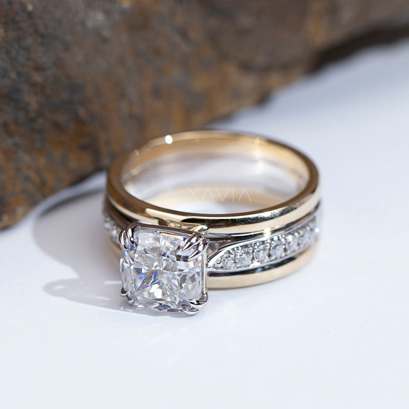 top view of cushion cut lab grown diamond engagement ring featuring four claw prongs, pavé diamond split band, and polished gold companion band in luxury two tone bridal design
