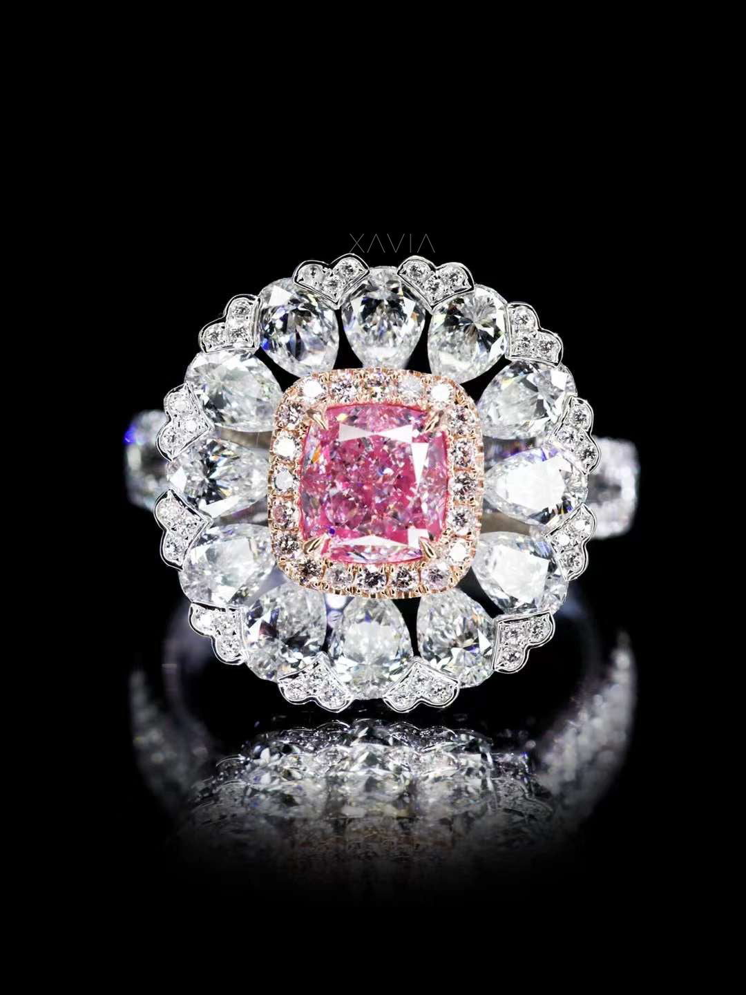 close-up of cushion cut fancy pink lab diamond ring with double halo of pear and round diamonds