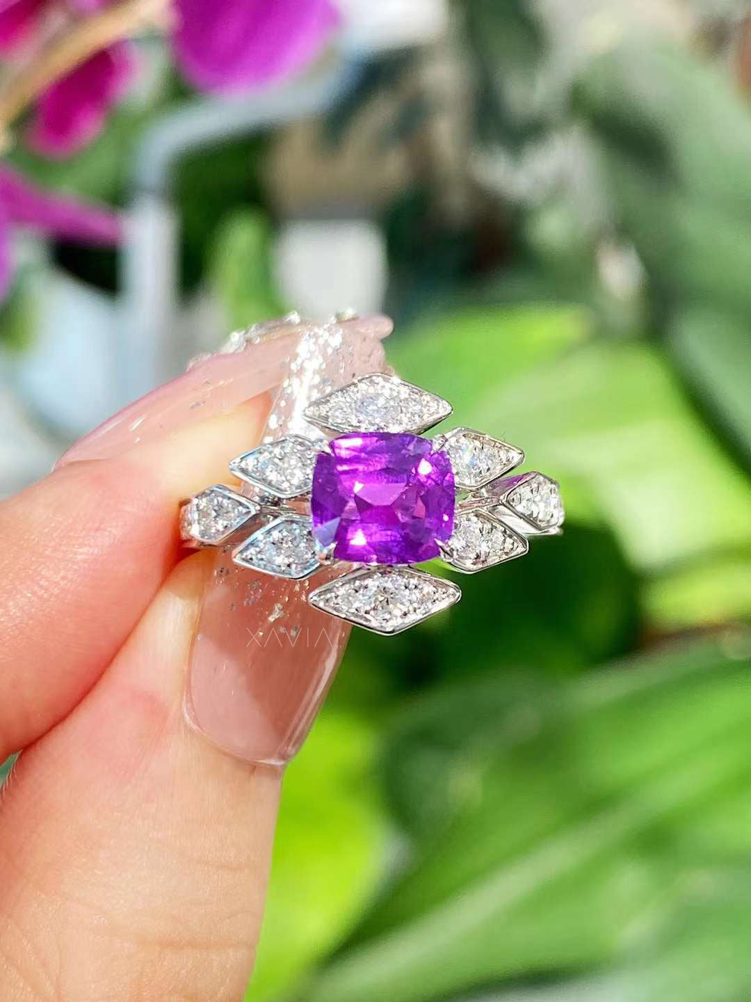 Close-up view of cushion-cut purple center stone ring with marquise-shaped lab-grown diamonds forming a sculptural floral halo