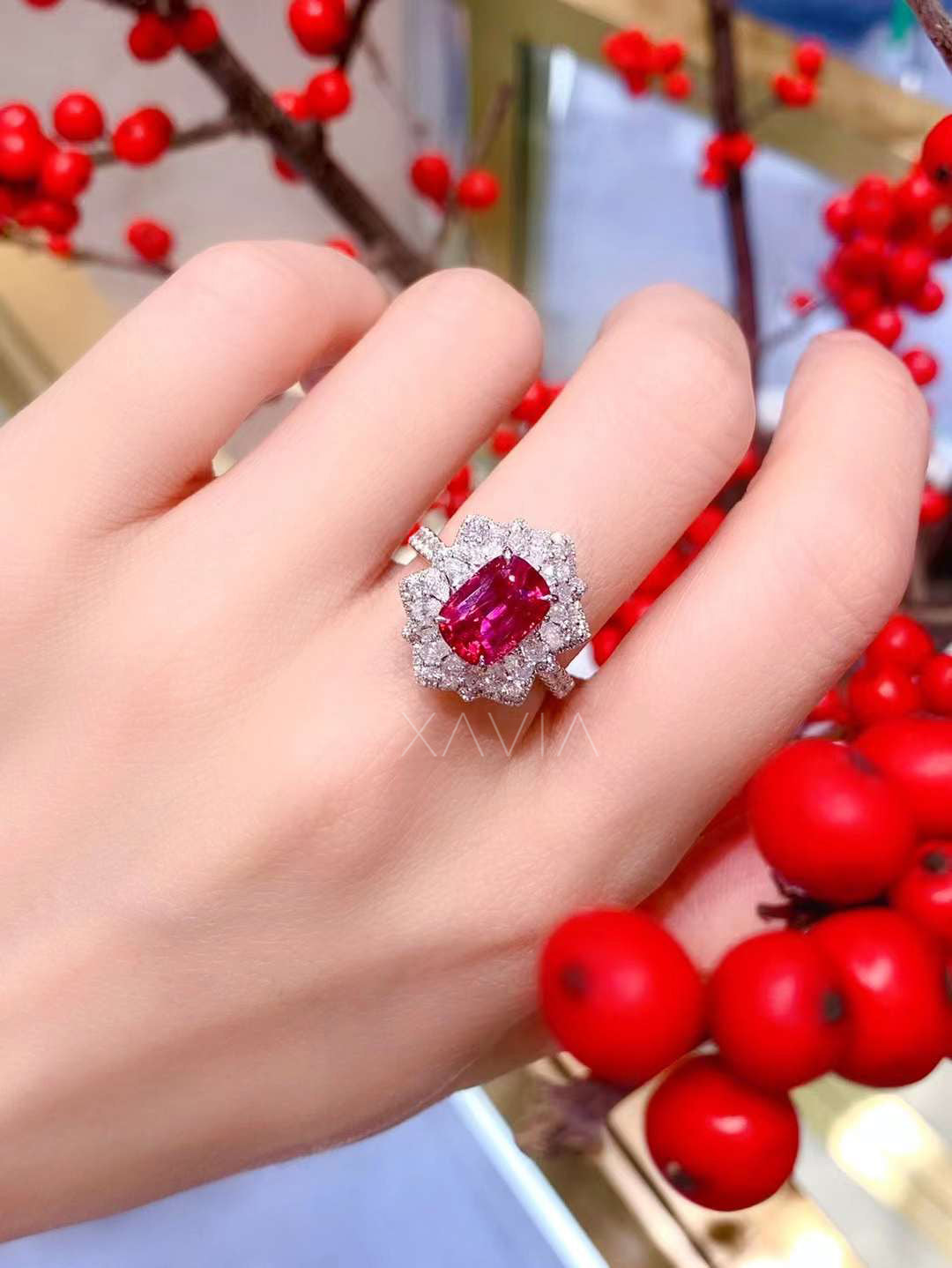 Cushion-cut ruby halo ring with floral diamond cluster design worn on hand, luxury platinum engagement cocktail jewelry