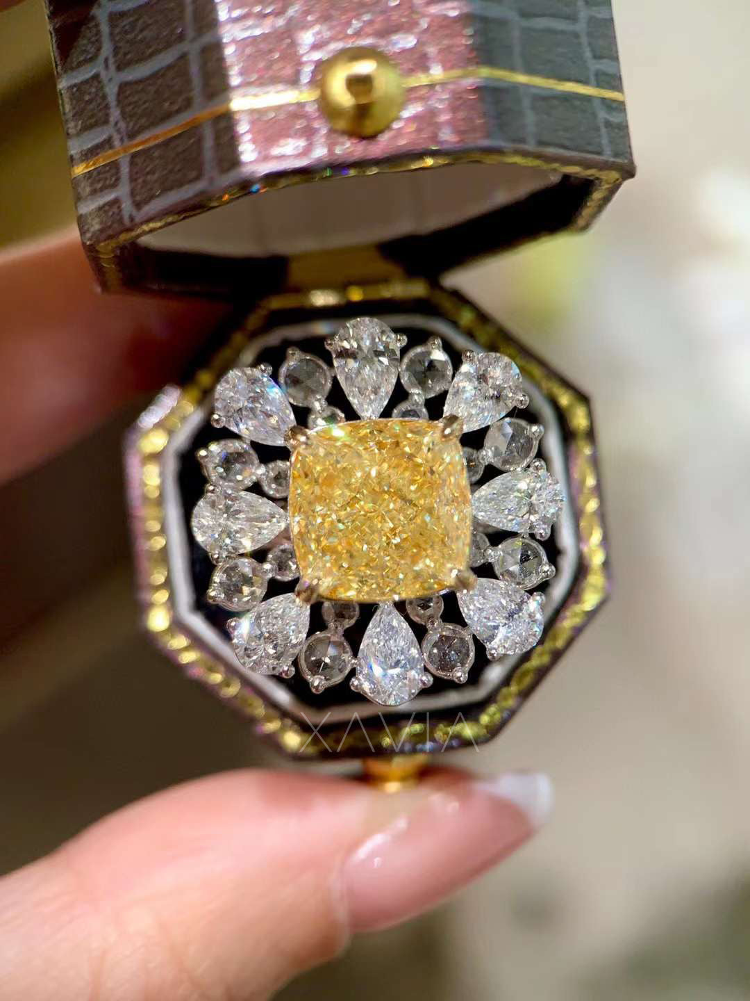 elegant model hand wearing cushion fancy yellow diamond cocktail ring with pear halo lab diamonds, showcasing bold statement jewelry design