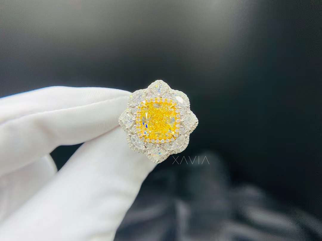 Cushion cut yellow lab grown diamond engagement ring with marquise floral halo worn on hand, showcasing layered brilliance and high polish gold craftsmanship