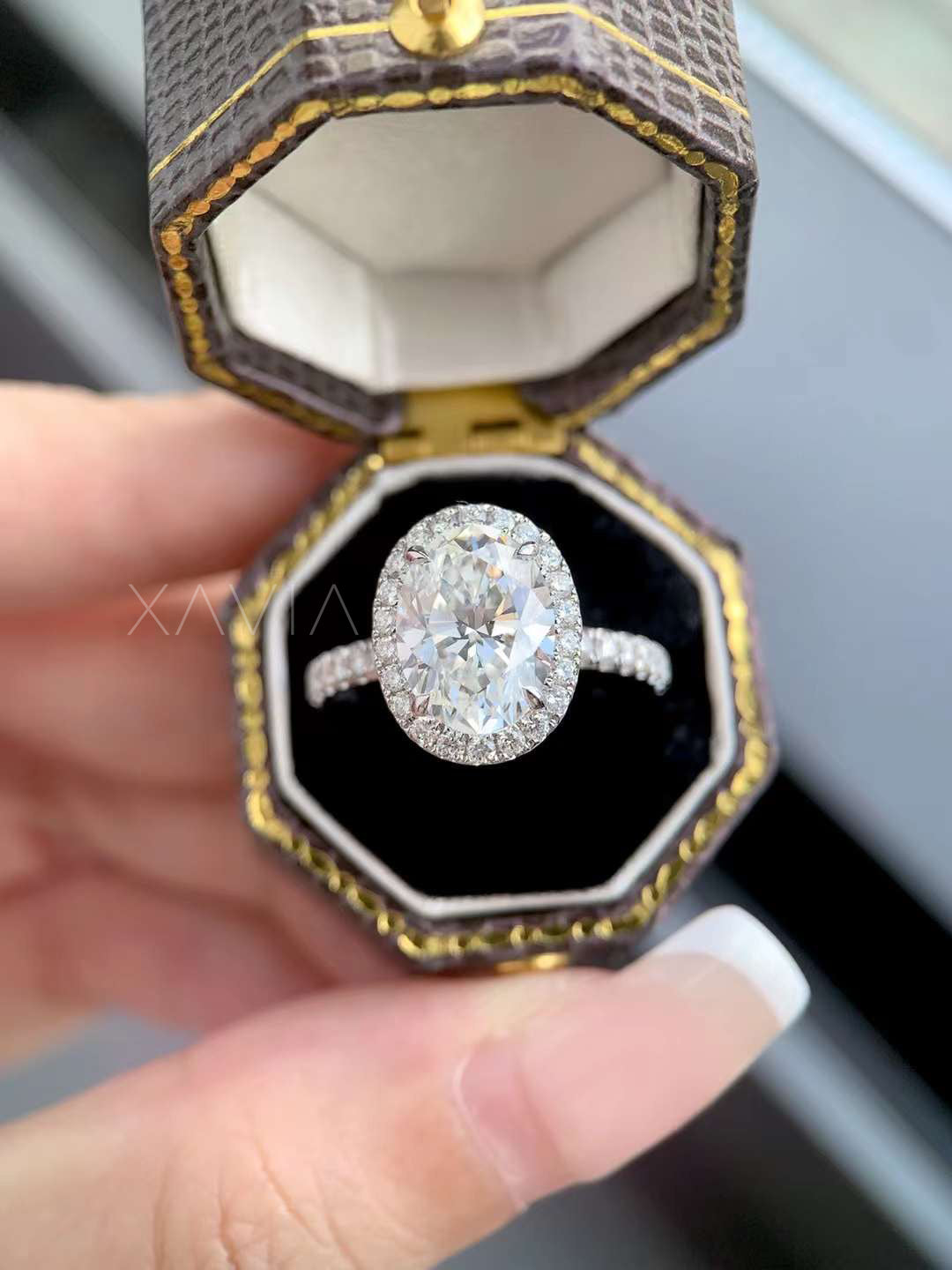 Sparkling oval cut halo diamond engagement ring with pavé band, close-up view highlighting brilliance and symmetry