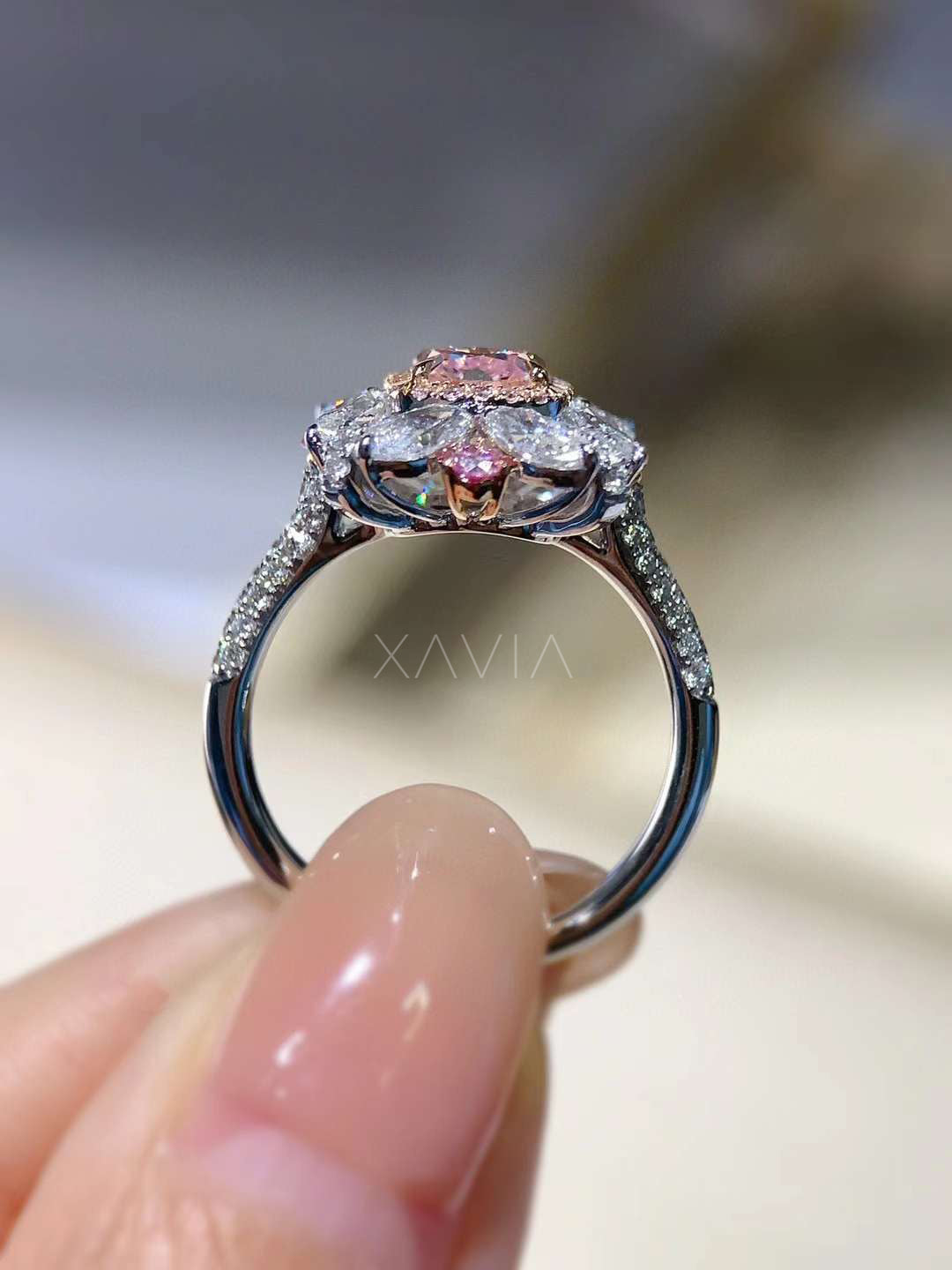 side view of pink cushion diamond ring with floral basket halo