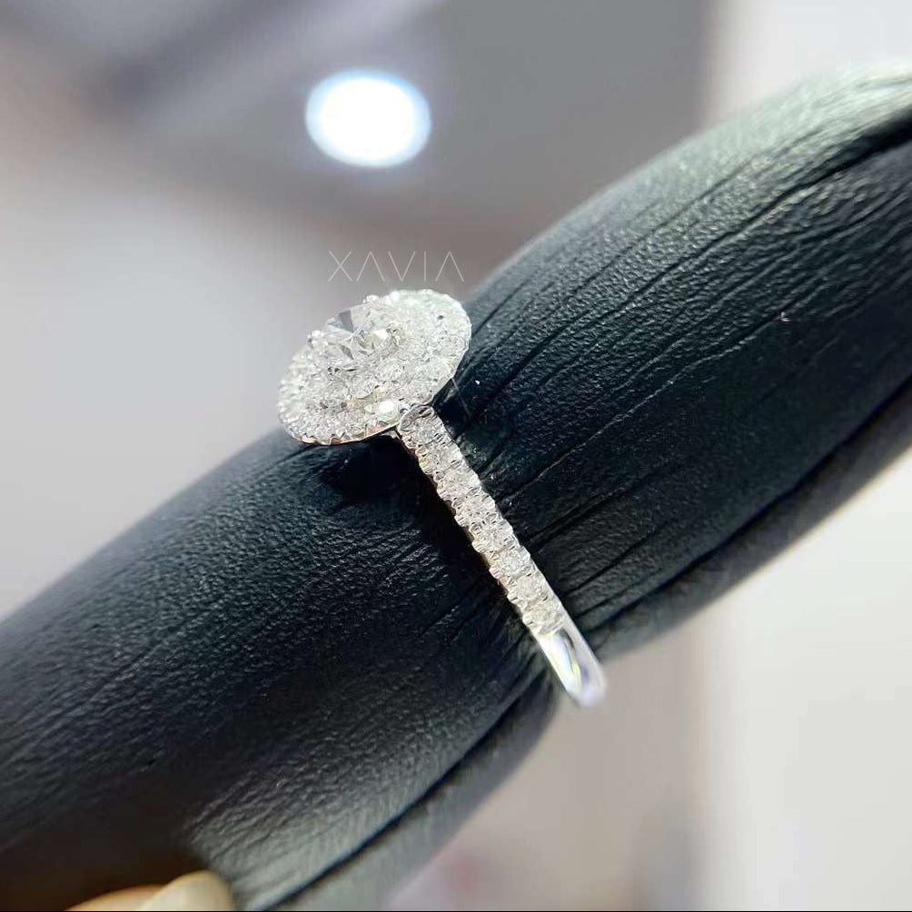 Side profile of round halo lab diamond engagement ring displaying elevated setting and pavé diamond shank