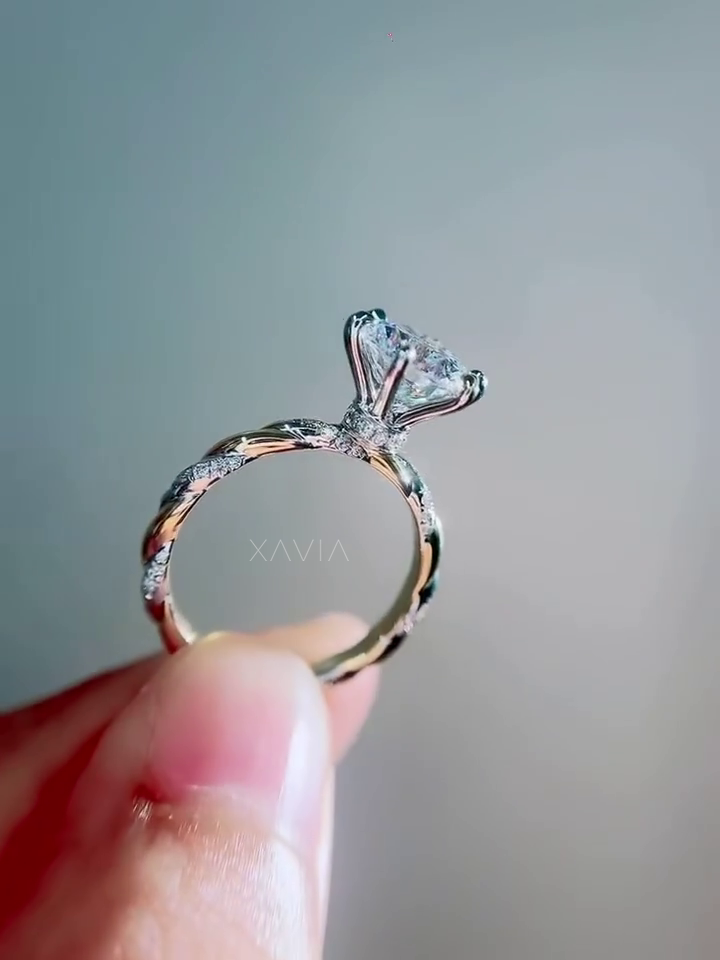 angled view of round brilliant lab diamond engagement ring with sculpted twisted band and delicate pavé diamonds reflecting light along the shank