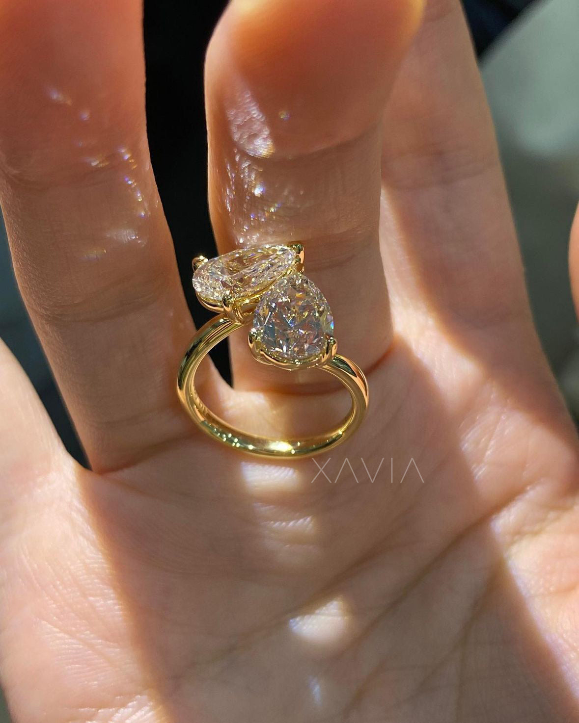 pear cut toi et moi ring with lab diamonds in yellow gold on hand