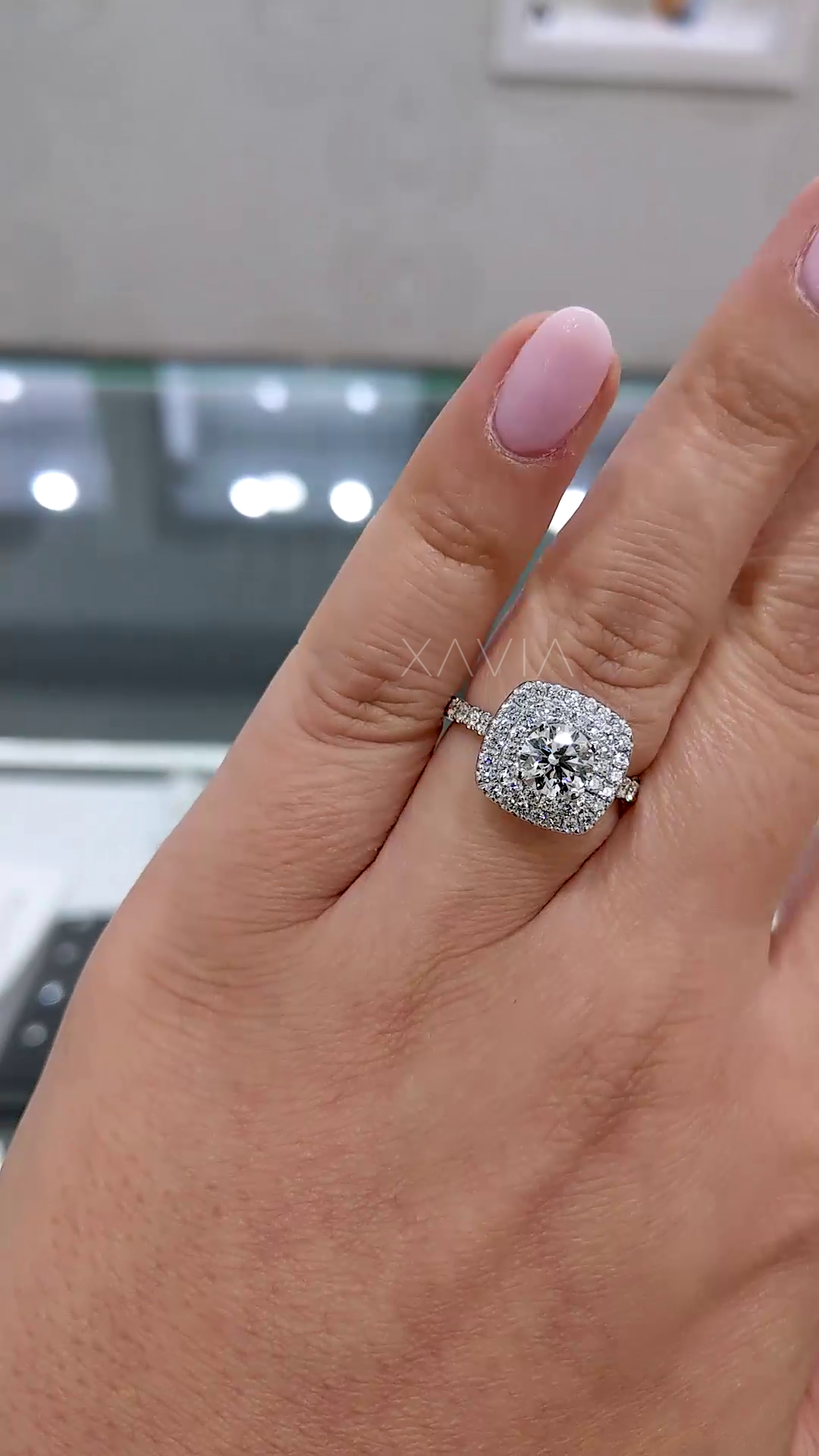 double halo cushion shape lab grown diamond engagement ring with round brilliant center worn on hand featuring micro pave band and luxury sparkle