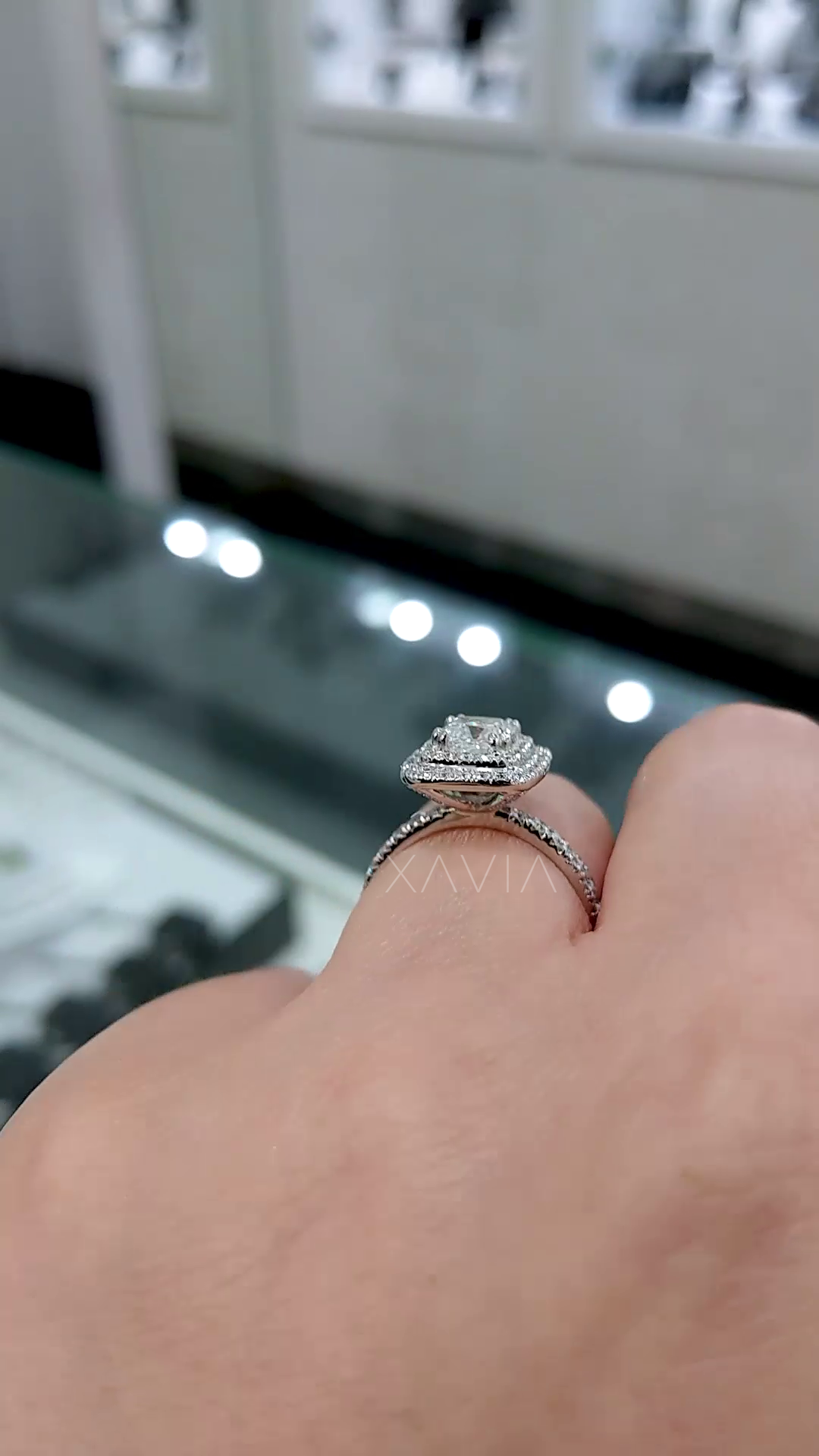 side profile of cushion halo engagement ring showing elevated gallery double halo structure and pavé diamond band detailing