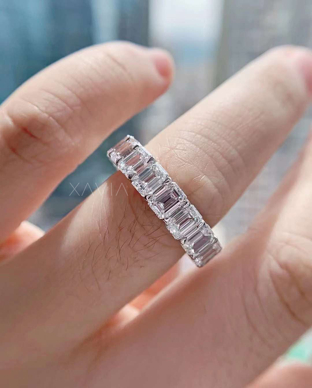 Soft daylight shot of Elara on hand, diamonds glowing with calm radiance against urban glass blur.