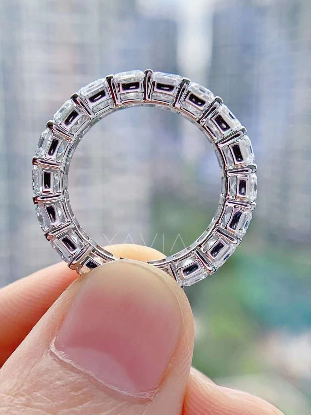 Inner view of the ring held against city backdrop, highlighting smooth comfort-fit interior and refined metalwork.