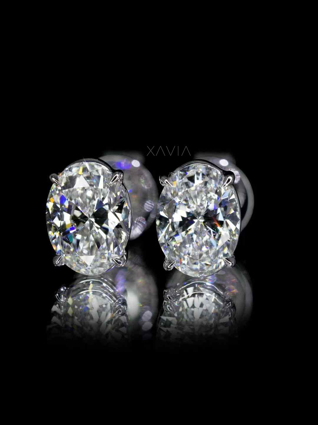 High contrast studio shot of oval diamond studs against black background