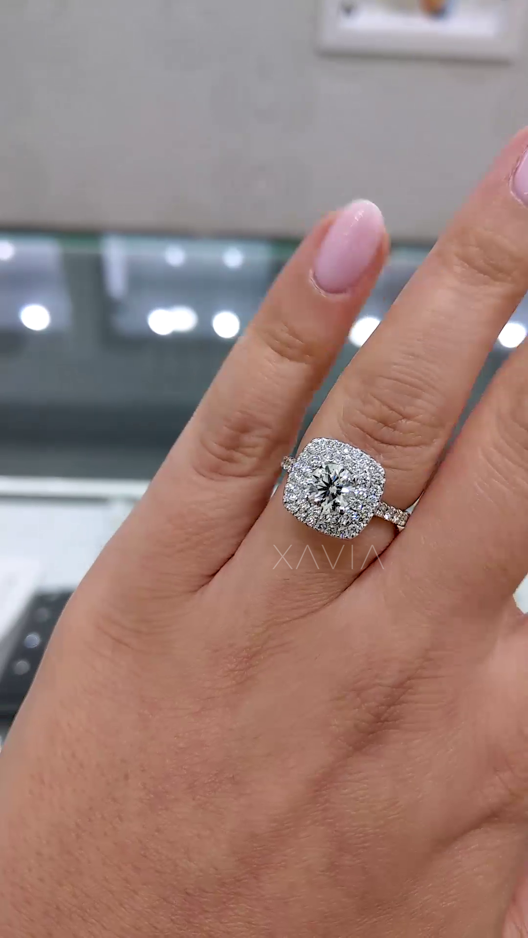 elegant bridal ring featuring double halo cushion design with micro pavé band worn on finger emphasizing luxury engagement jewelry