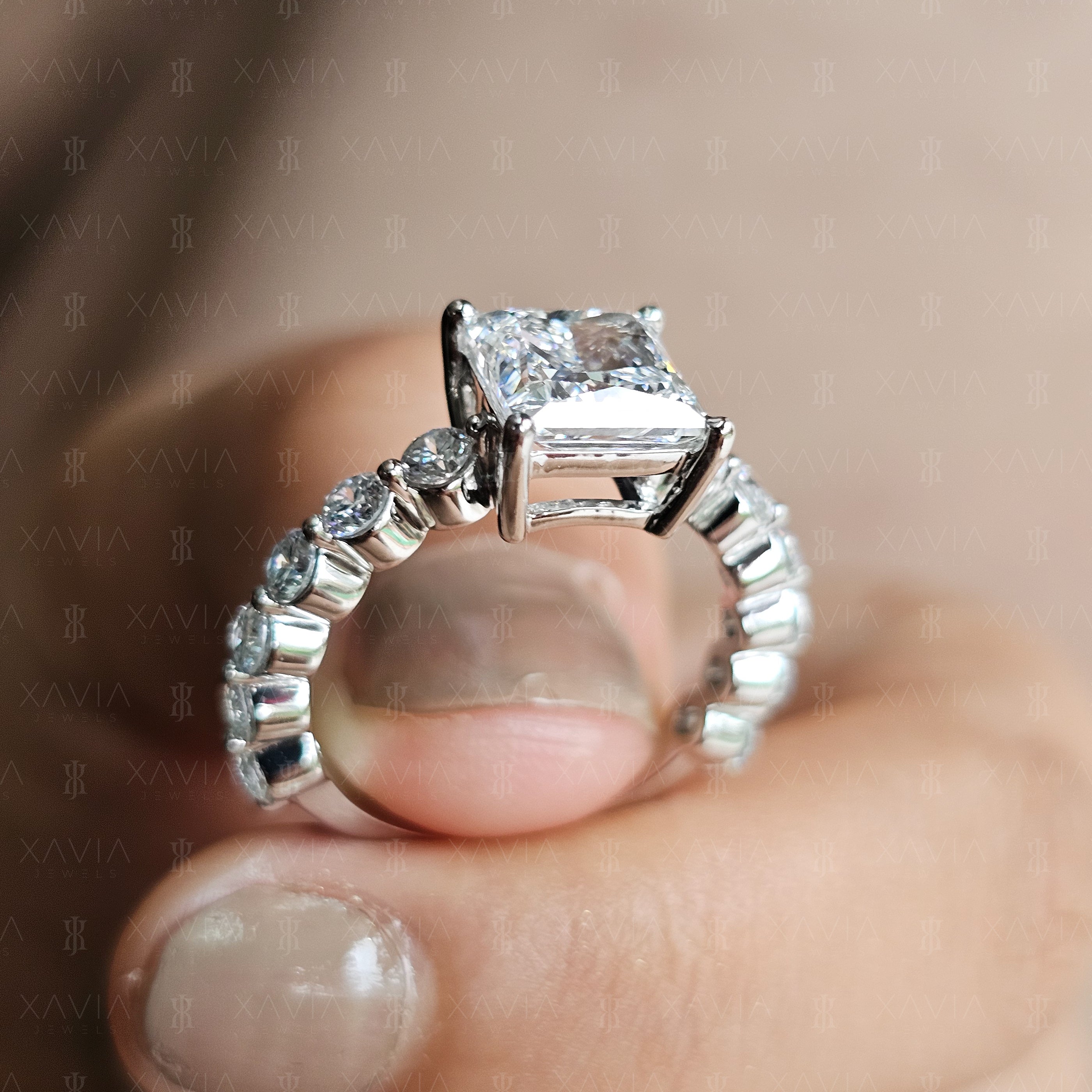 Detailed side angle of elevated princess cut solitaire ring with sculpted basket gallery and round brilliant eternity diamonds across the band