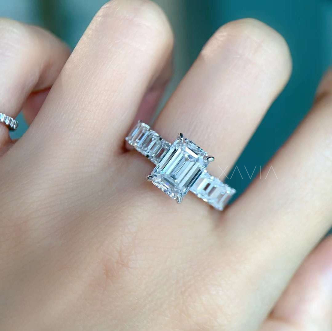 emerald cut lab diamond engagement ring worn on model’s hand