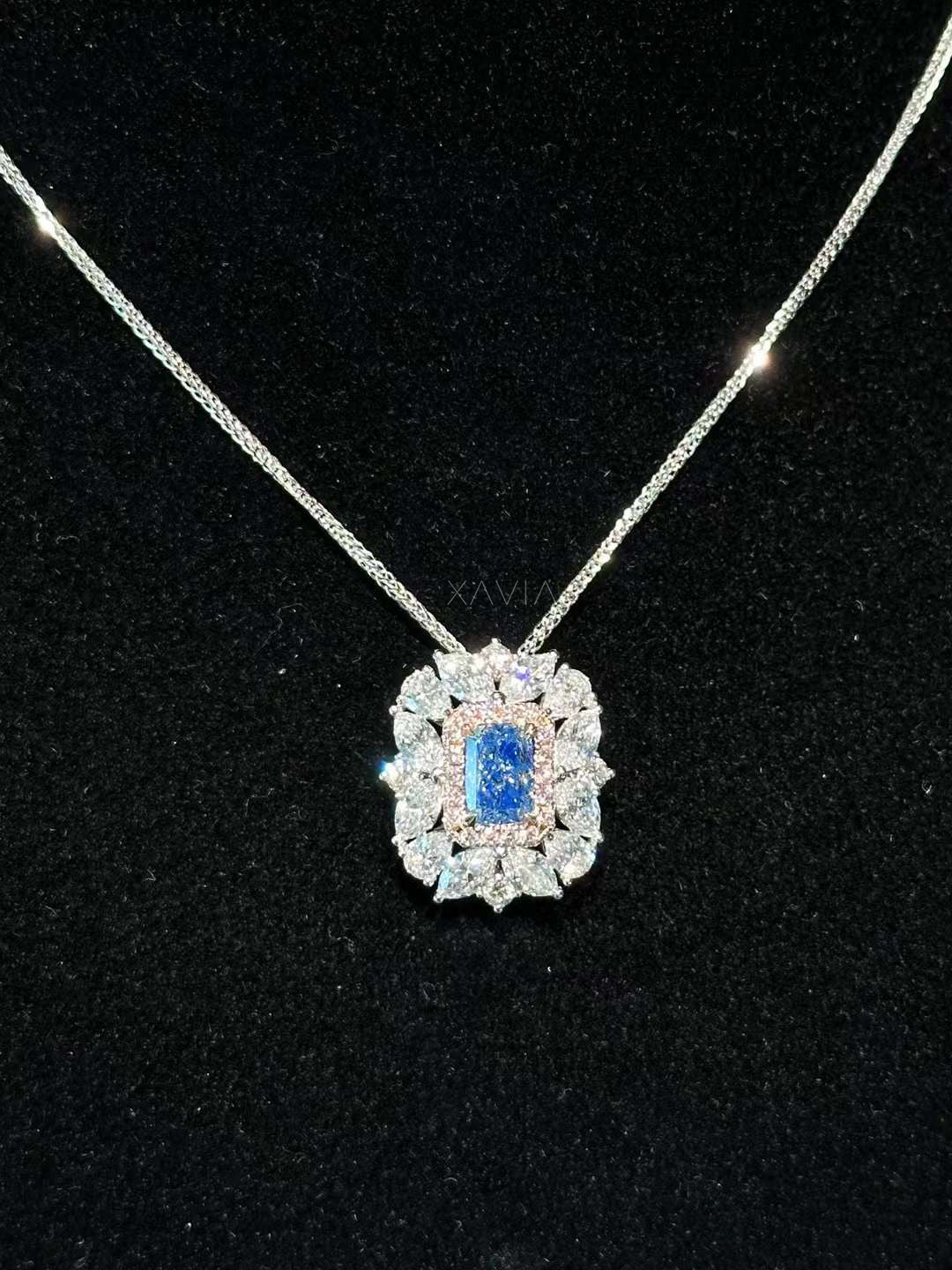 luxury emerald-cut lab blue diamond pendant with floral diamond halo on platinum chain