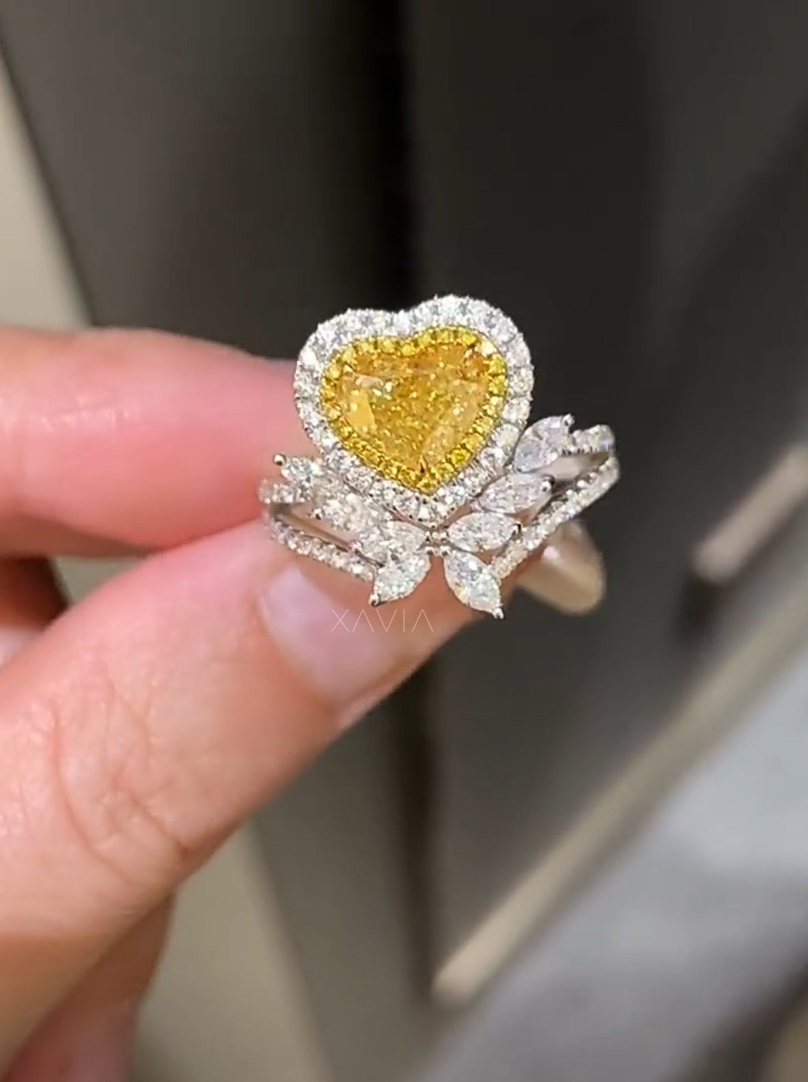 closeup of fancy yellow heart diamond engagement ring with dual halo and marquise floral accents in platinum setting