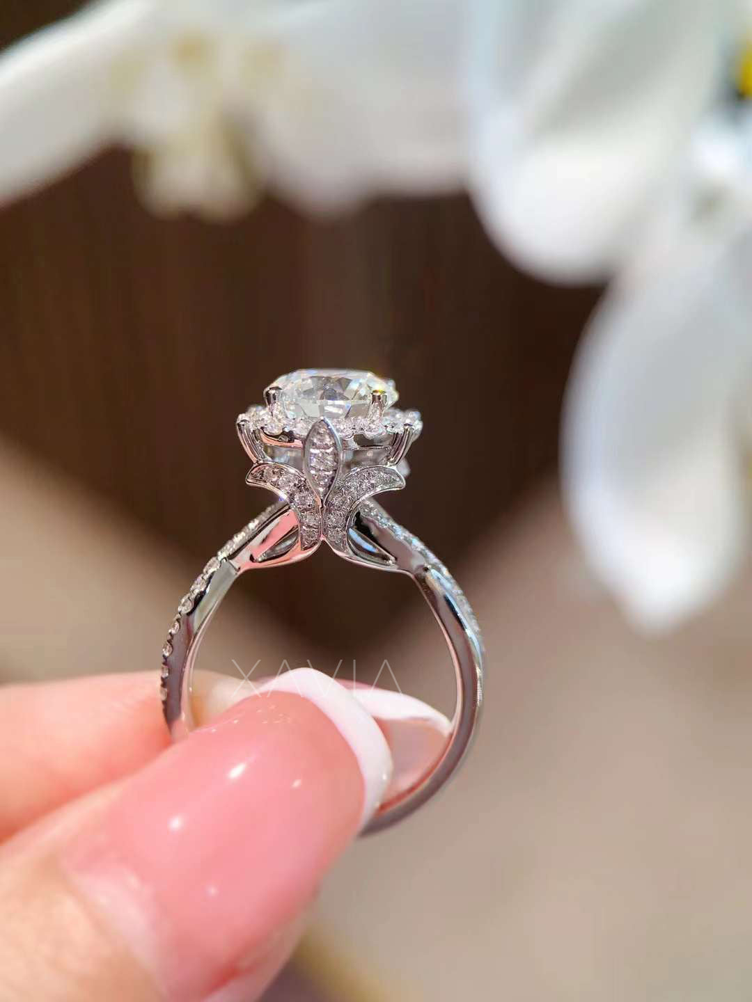 Side angle view of floral-inspired cathedral setting with marquise diamond petals and pavé split shank on round cut halo engagement ring