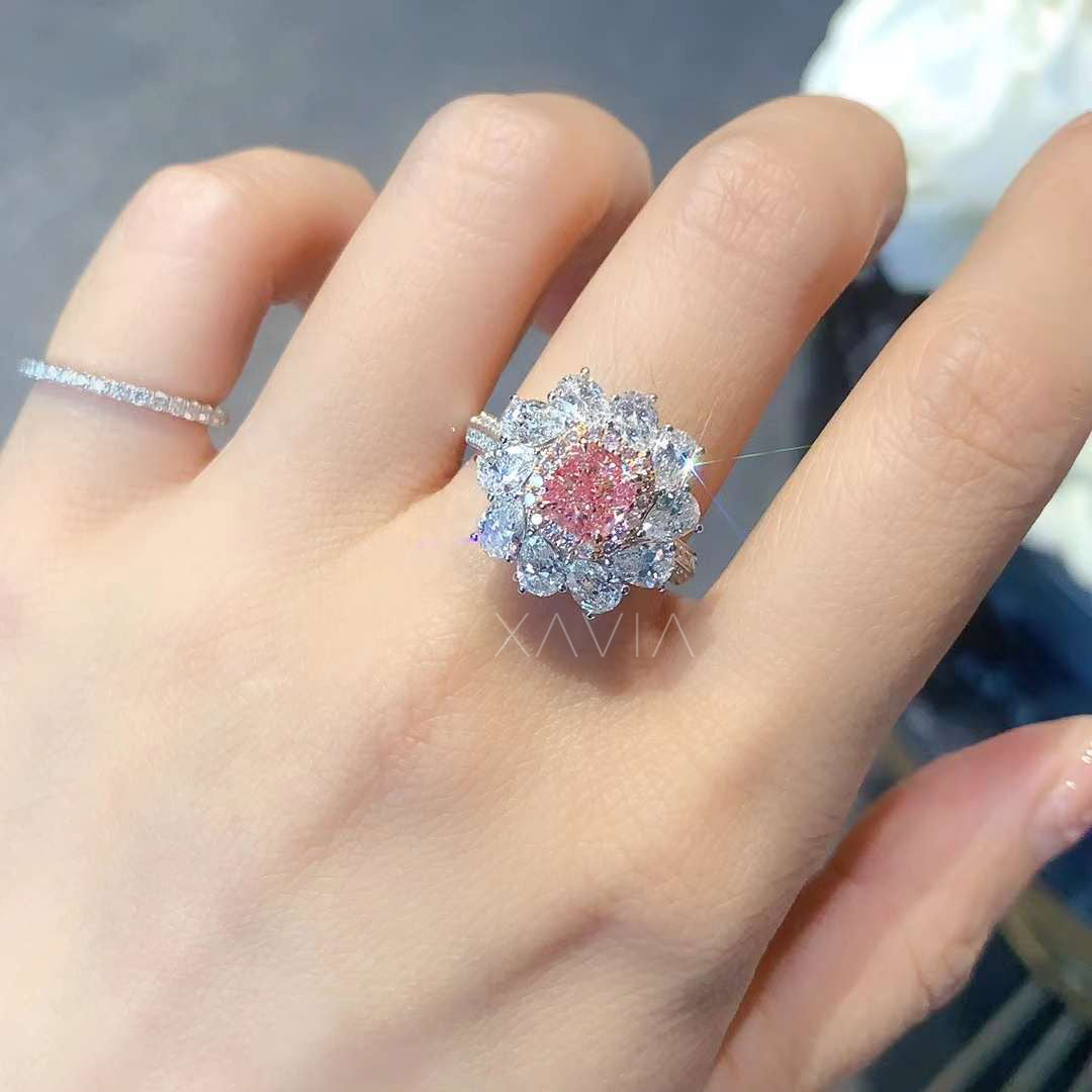 floral-inspired pink cushion cut diamond ring worn on model’s hand
