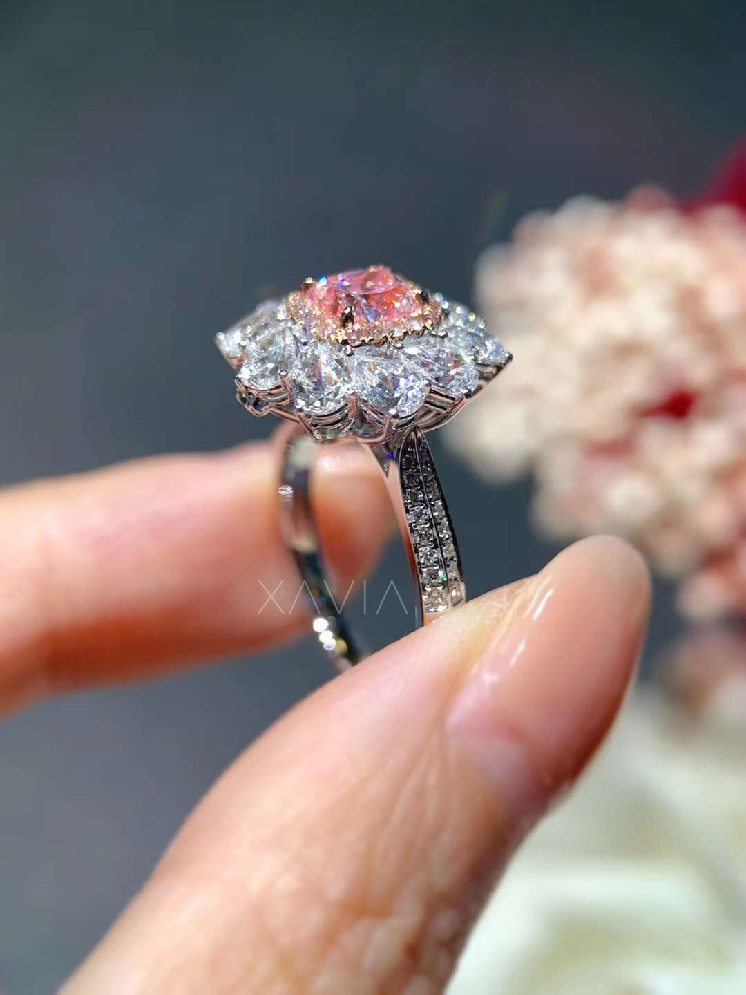 angled view showing floral prong basket of pink diamond engagement ring