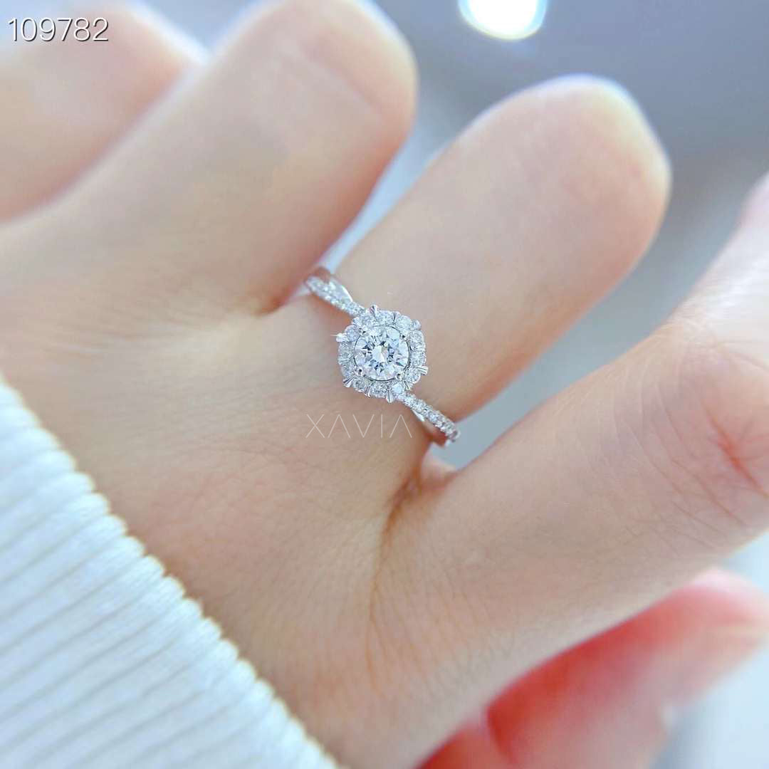 top view of round brilliant lab diamond ring showing marquise floral halo arrangement and pavé diamond shoulders