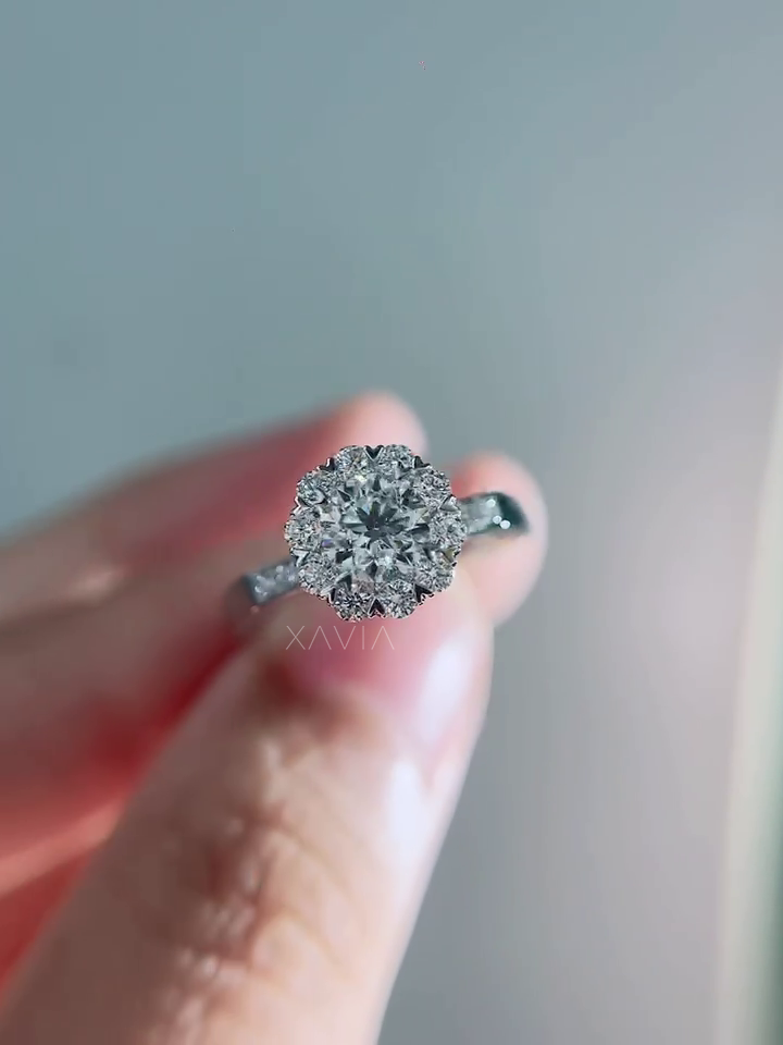 Sparkling top perspective of round diamond halo engagement ring showcasing floral halo arrangement and brilliant pavé diamonds along the band