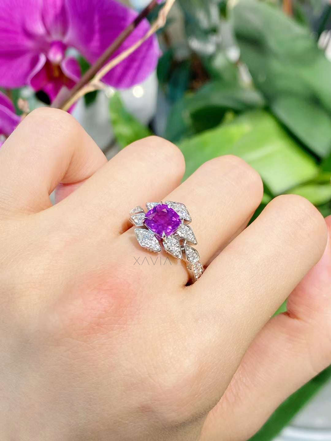 Top view of cushion purple gemstone ring featuring symmetrical marquise lab-grown diamond halo in a high-polish white metal finish