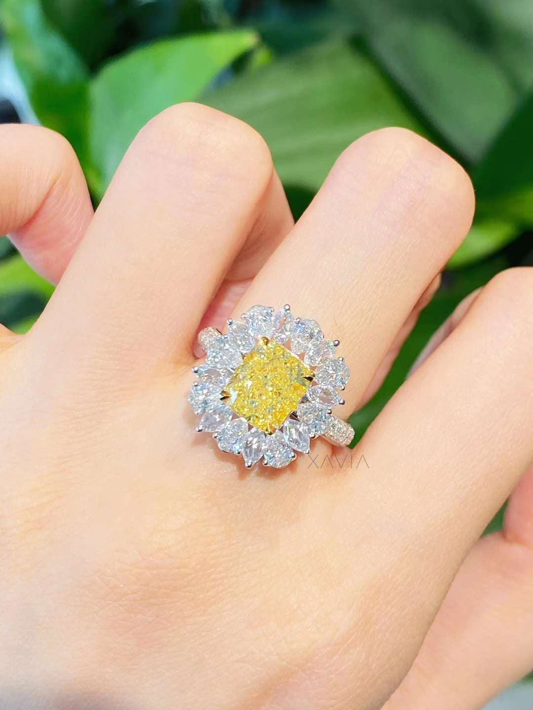 Top view of floral halo engagement ring with yellow cushion lab diamond surrounded by marquise and pear cut diamonds