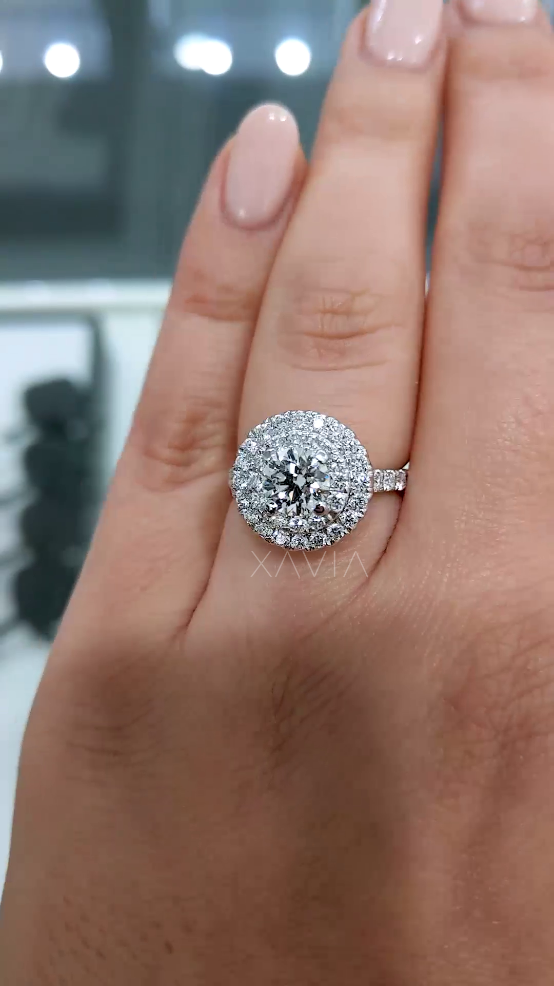 front facing view of round lab grown diamond ring with double halo setting and slim pavé band capturing maximum light reflection and fire